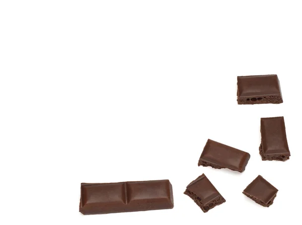 Close up of dark porous chocolate pieces on white background — Stock Photo, Image