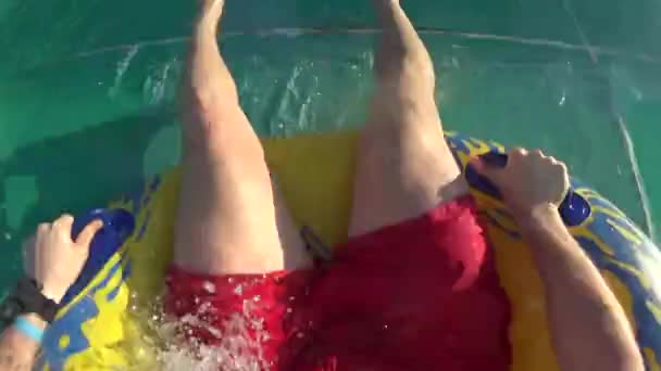 Gopro of Man Rolled Down Slide on Rubber Rings — Stock Video