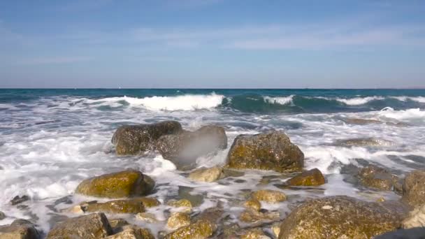 Olas de agua salpicando sobre piedra que sobresale del mar — Vídeos de Stock