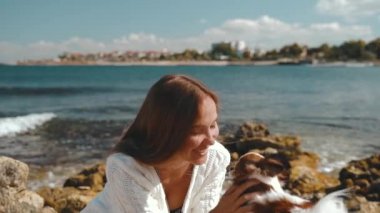 Genç yetişkin bir kız köpekle vakit geçiriyor.