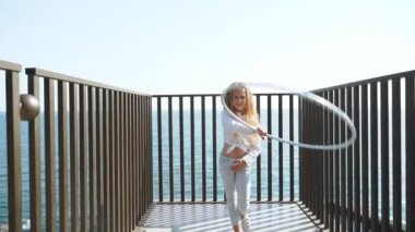 Teenage girl playing with hula hoop equipment