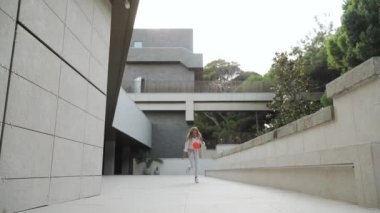 Youth girl playing with red gymnastic ball