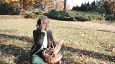 Young adult lady resting in park at sunny day