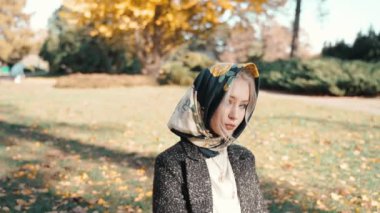 Young adult girl spending sunny autumn day outdoors
