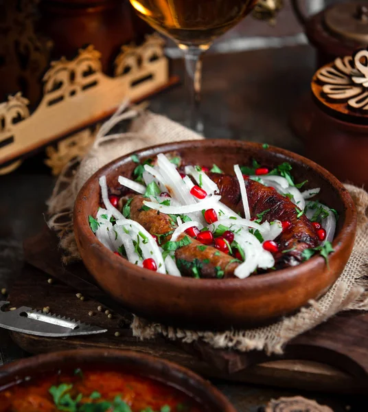 Georgian dish kupata with onions and pomegranate — Stock Photo, Image
