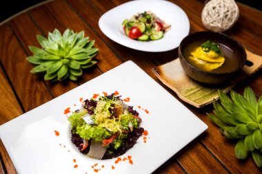 Öğle yemeğinde deniz ürünleri salatası, mantı çorbası ve sebze salatası.