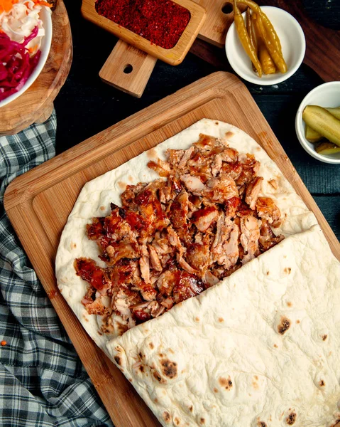 chicken doner kebab in flatbread served with pickled cucumber and