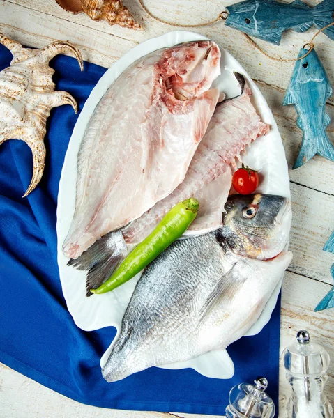 Half-cut fish fillets served in a plate with pepper — Stock Photo, Image