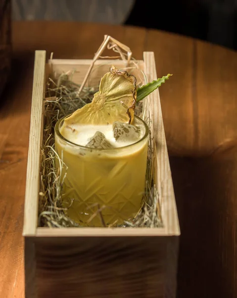 Pineapple cocktail with ice and dried pineapple serve in wood — Stock Photo, Image