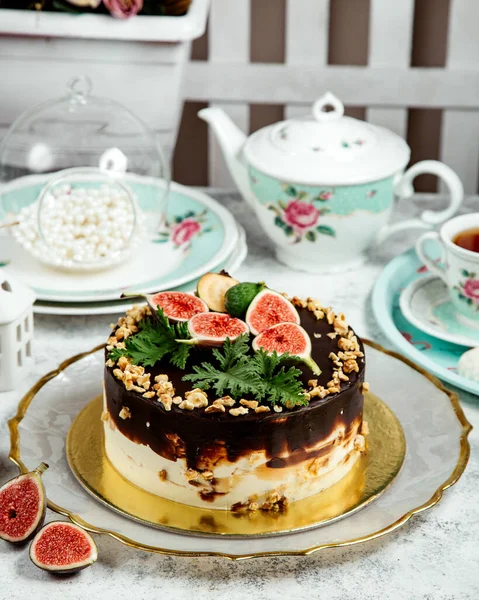 Choloate cake topped with walnuts and fruits — Stock Photo, Image