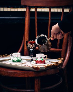 a person pours coffee in cup