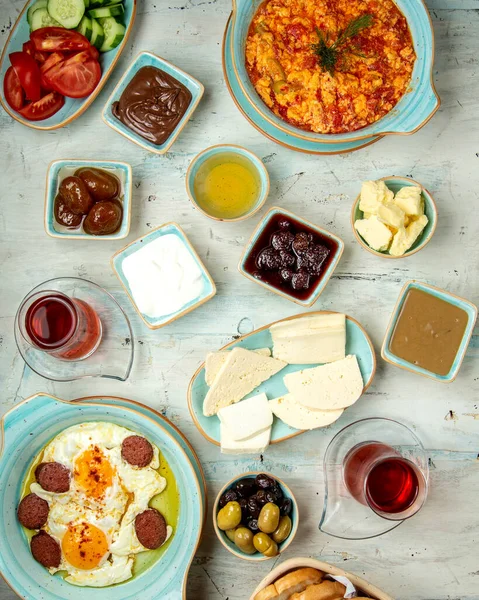 Farklı türde kızarmış yumurtalardan oluşan kahvaltı masası. Peynir, ballı çikolata ve çay. — Stok fotoğraf