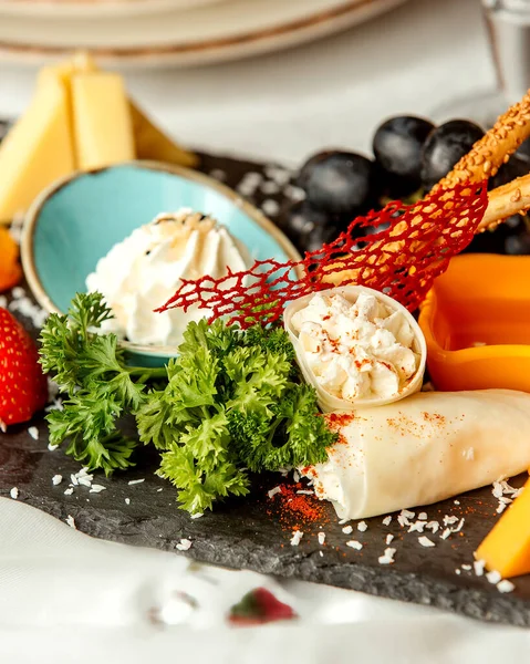 cheese plate with crackers and grape