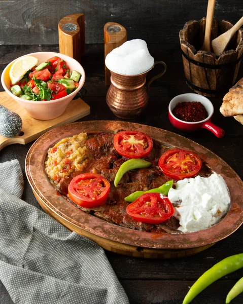 a platter of iskender kebab served with aubergine salad and yoghurt
