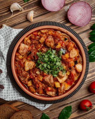 Kızarmış kuzu, karamelli soğan, sebze ve yeşillik.