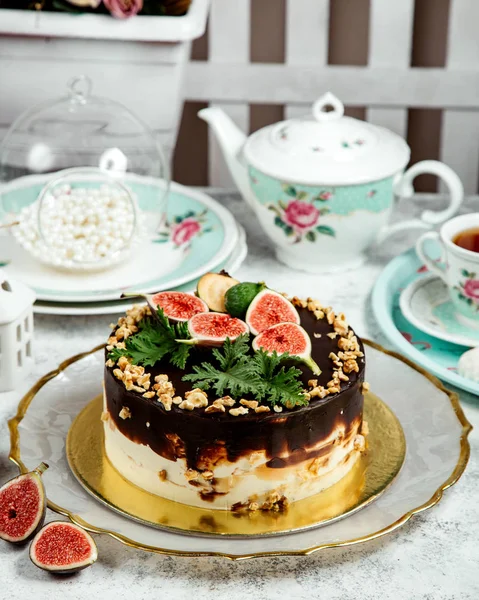 Choloate cake topped with walnuts and fruits — Stock Photo, Image
