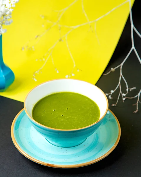 Миска зеленого овощного супа в бирюзовой керамической миске — стоковое фото
