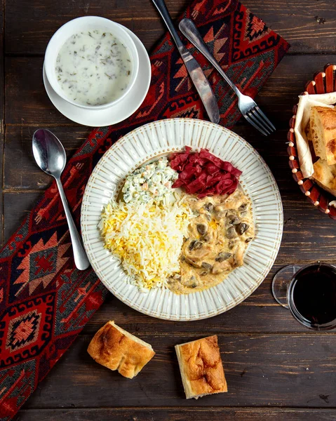 Mushrooms in sauce rice and russian salad — Stock Photo, Image