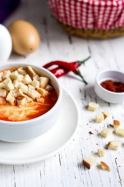 Tomato soup topped with crackers and cheese — Stock Photo, Image