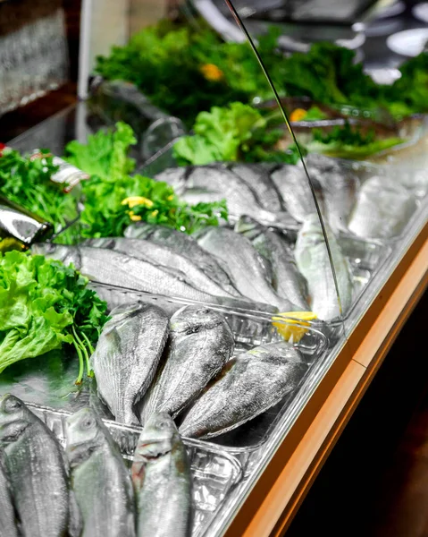 raw fish in refrigerator display of the restaurant