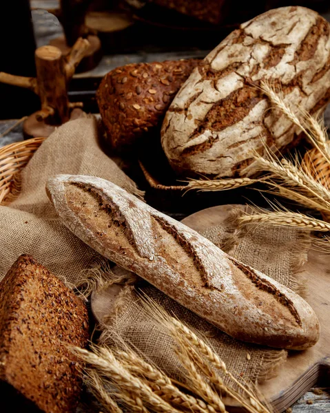 Organic whole grain baguette placed on linen fabric — Stock Photo, Image