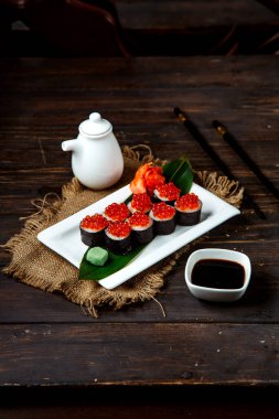 sushi rolls topped with caviar ____