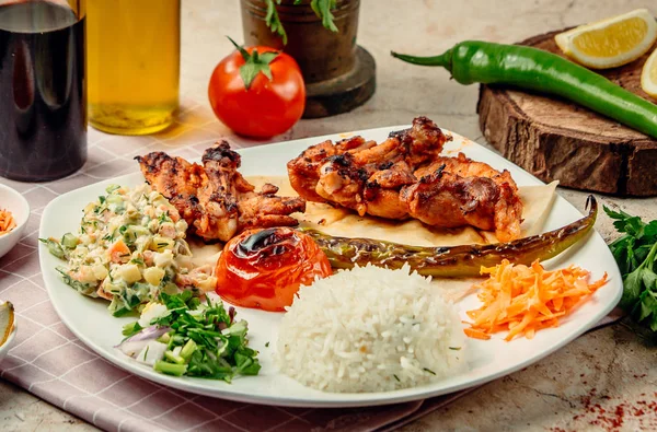 chicken kebab with rice and vegetables