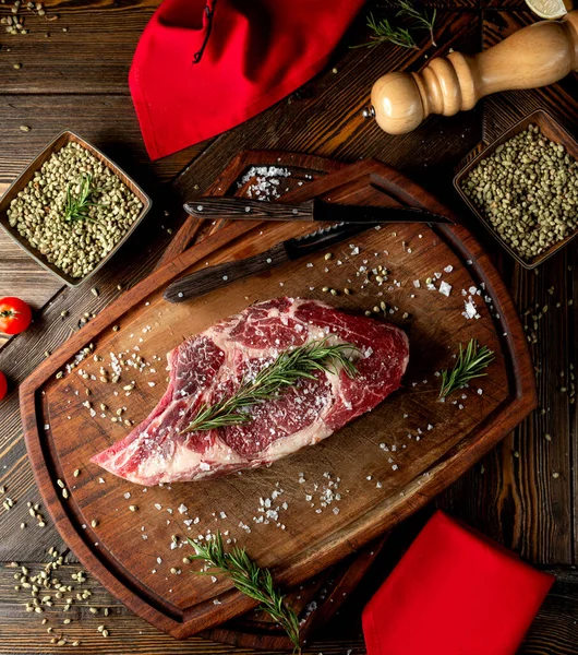 Rebanada de carne cruda cubierta con hierbas y sal —  Fotos de Stock
