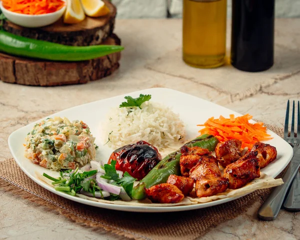 chicken kebab with rice and vegetables