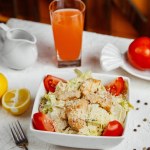 Chicken caesar salad with tomato lettuce parmesan and bread stuffing