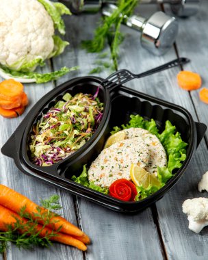 sliced herbal salad and cutlets