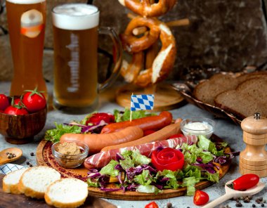 various sausages with herbs and glass of beer