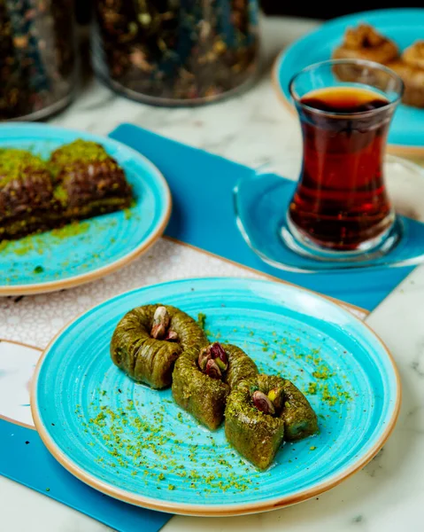 sweets with pistachio and black tea