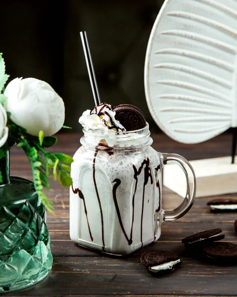 milkshake with chocolate syrup and cookie