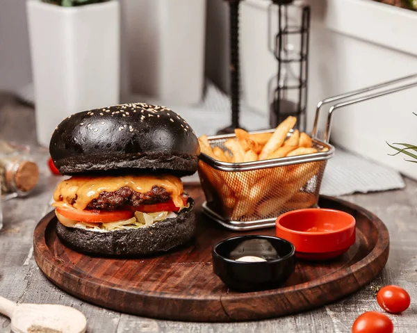 Cheeseburger Czarną Bułką Frytkami — Zdjęcie stockowe