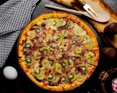 fruit pizza with kiwi banana blackberry and strawberry