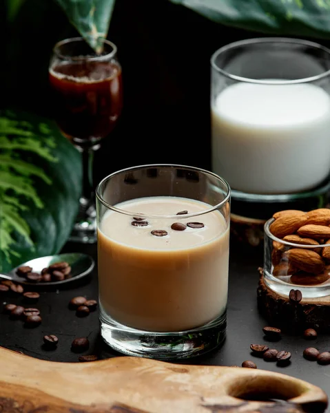 a glass of coffee cocktail garnished with coffee beans