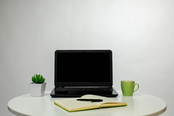 cozy workspace with black laptop