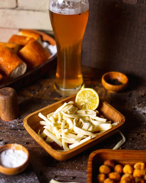 side view string cheese with beer  salt  pepper and bread