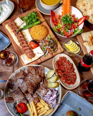 Akşam yemeği, kebap salatası, ekmek, kızarmış et ve patates kızartması.