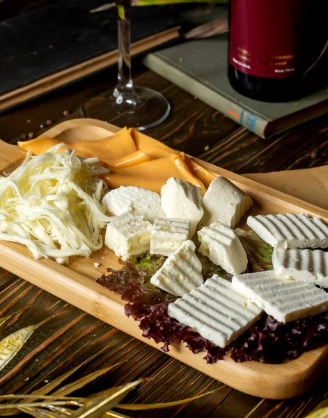 cheese plate with white cheese string cheese and yellow cheese