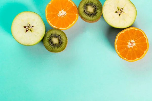 halved fruits on a blue table