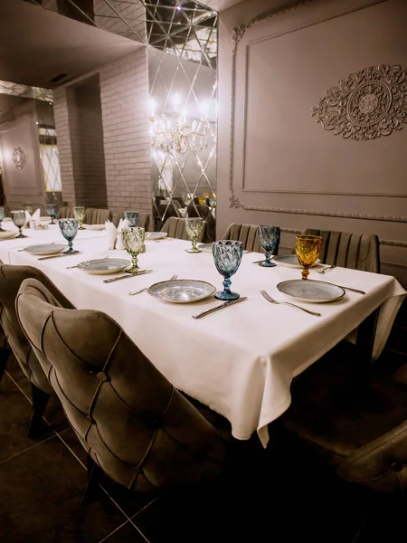 grey painted fancy restaurant with empty dinner table