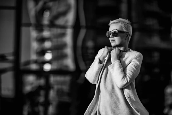 Young woman, blonde, walks in sunglasses — Stok fotoğraf