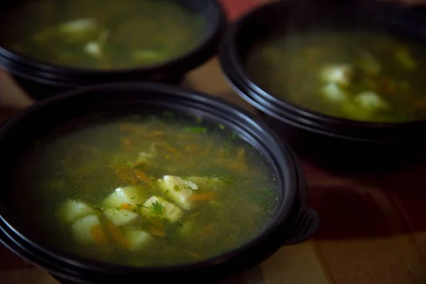 soup in a disposable bowl for food delivery to the house during the quarantine