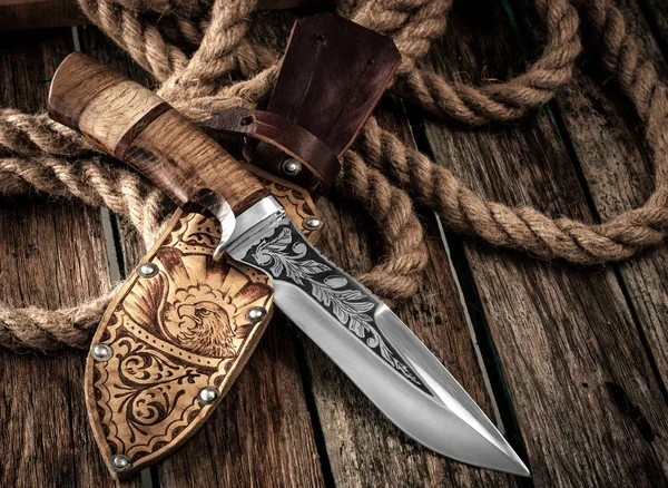 Hunting Knife with leather sheath on a wooden table. — Stock Photo, Image
