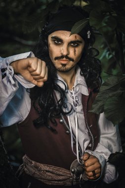 Korsan kostümlü adam portresi açık poz veriyor.