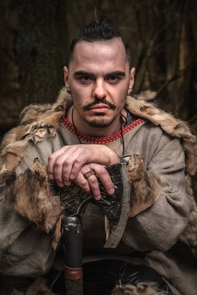 Porträt eines Wikingerkriegers mit Axt im Wald. — Stockfoto