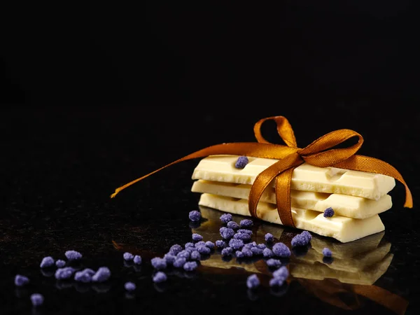 Pieces of white chocolate on dark marble. — Stock Photo, Image