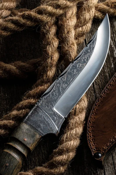 Hunting knife handmade with patterns on the old wooden backgroun — Stock Photo, Image